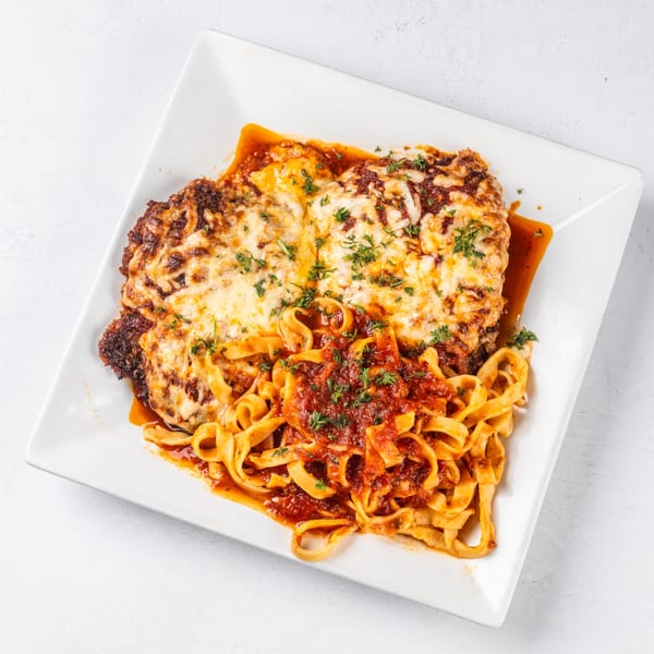 Hampton Junction's chicken parmesan with melted cheese and fettuccine pasta in red sauce.