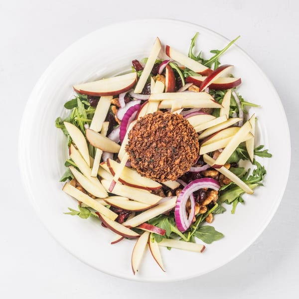 Hampton Junction's salad with arugula, apple slices, red onion, walnuts, and a crispy fried goat cheese medallion.